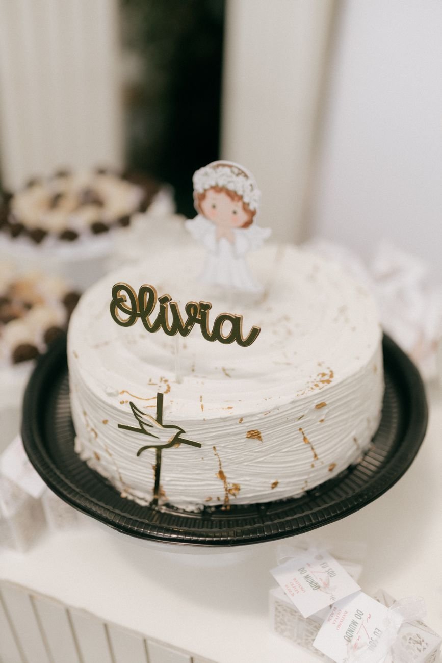 A beautifully decorated white cake featuring elegant script decoration.